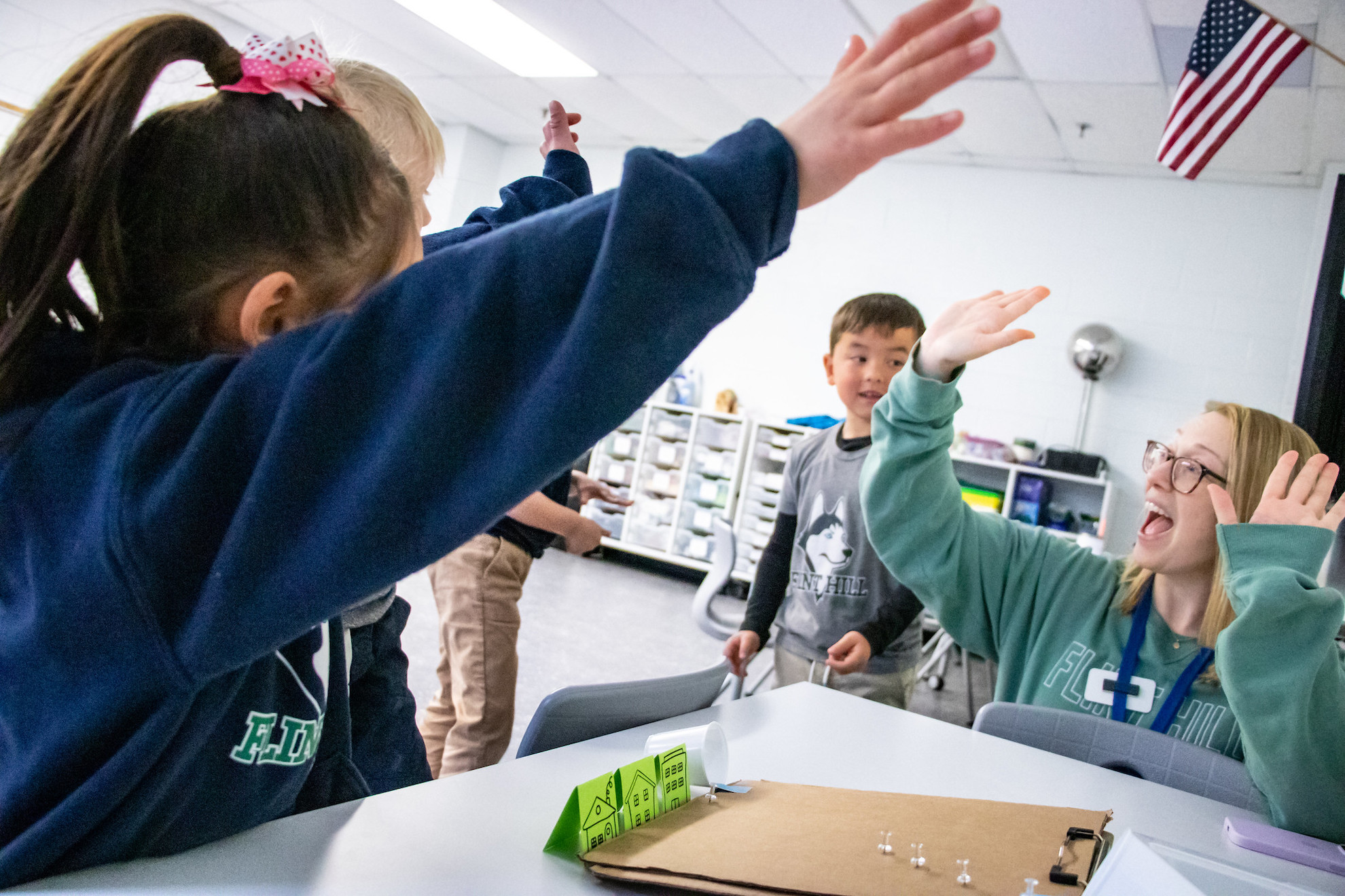 52816364972_e103f17584_k Students are always encouraged to “think like a scientist.” In this lab, Kindergarteners apply fundamental physics principles. They work in pairs to build structures to protect a mountain town from falling boulders (ping pong balls). Using a mountain model made of inclined cardboard, students design and test their own solutions to re-direct the “boulders” away from their paper town and toward a waiting dump truck (a plastic cup).