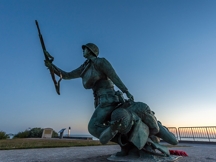 War memorial on Omaha beach in Normandy France at sunrise